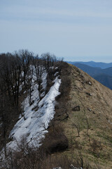 Snow on ridge on one side of cliff because of shade in early spring. Landscape and beautiful untouched nature. Mount Peus in Tuapse district in southern Russia.