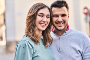 Man and woman smiling confident standing together at street