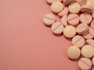 Pink pills on a pink background. Medical tablets.