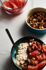 Overnight oats with milk and greek yogurt. healthy breakfast with nuts with grapefruit, honey and cinnamon