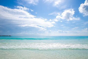 Beautiful sandy beach with people relaxing in a resort in Cancun, Mexico. Summer and sunshine.
