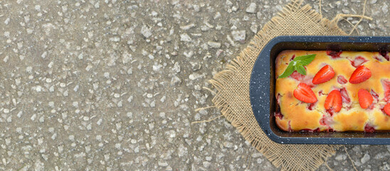 Delicious summer dessert strawberry pie, sweet homemade holiday cake decorated with mint leaves on a light concrete background.