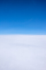 View from the porthole, separation of the sky and clouds by the horizon