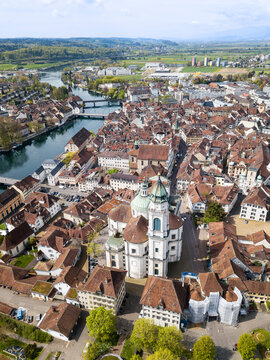 Aerial views of the old town of Solothurn city with St. Ursus Cathedral - a Swiss heritage site of national significance - in the center.