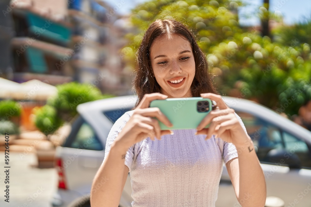 Poster Young woman smiling confident watching video on smartphone at park