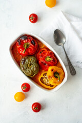 Baked bell pepper with meat and rice in a ceramic bowl on a light background. Stuffed pepper, halves of peppers stuffed with meat and rice, biber dolmasi