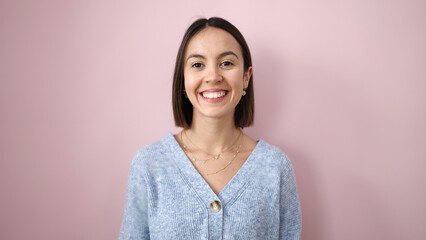 Young beautiful hispanic woman smiling confident standing over isolated pink background
