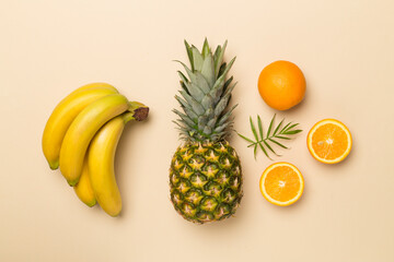 Fresh tropical fruits on color background, top view