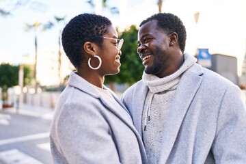 Man and woman couple smiling confident standing together at street