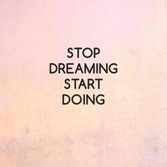 Stop Dreaming Start Doing text on concrete wall