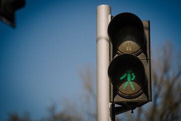 Fototapeta premium A pedestrian traffic light in close-up with a green light illuminated