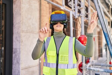 Young beautiful hispanic woman architect using virtual reality glasses at street