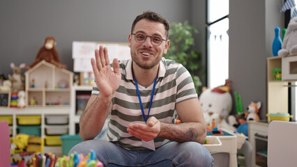Young caucasian man on a video call working as teacher at kindergarten