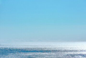 A view of the wide sea in the morning that sparkles in the sunlight