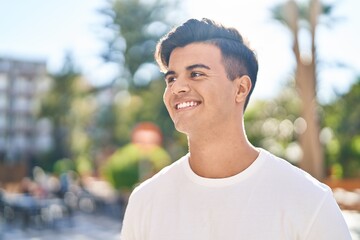 Fototapeta premium Young hispanic man smiling confident looking to the side at street