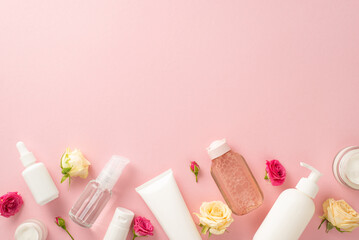 Experience the beauty of tender skincare with top view flat lay showcasing pump bottles, pipettes, cream bottles roses on a pastel pink background. The empty space is the perfect place for branding