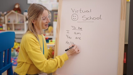 Young blonde woman on a video call working as teacher at kindergarten