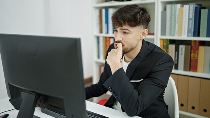 Young arab man student using computer studying at university classroom