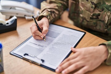 Young arab man army soldier signing contract at office