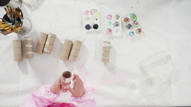 Flat lay. Kids papercraft. Painting empty toilet paper rolls with acrylic paint to create paper bugs.