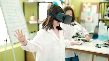 Fototapeta premium Adorable girls scientist student using virtual reality glasses at laboratory classroom