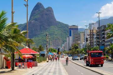 Ipanema and Leblon beaches with kiosk and mosaic of sidewalk, mountain Dois Irmao (Two Brother) in Rio de Janeiro, Brazil. - 597285496