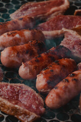 different meats smoking on the barbecue