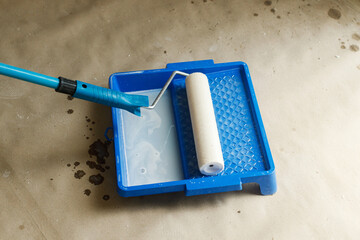 Roller brush and tray with prime close up for plaster walls. Construction of house and home...
