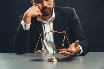 Lawyer or judge in formal black suit hold unbalanced scale with expression of disappointment trying...