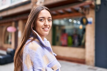 Young beautiful hispanic woman smiling confident standing at street