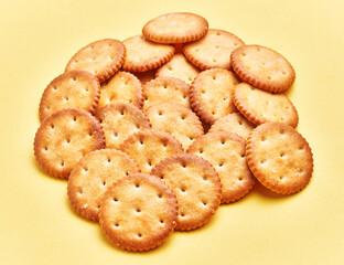  Delicious group of salty biscuits over isolated yellow background