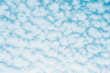 Blue skies with white clouds background with space for text, blue cloudy skies texture. 