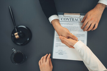 Top view lawyer or attorneys colleagues handshake after successful legal discussing on contract...