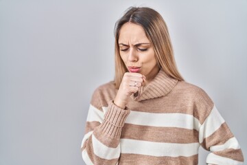 Young blonde woman wearing turtleneck sweater over isolated background feeling unwell and coughing as symptom for cold or bronchitis. health care concept.