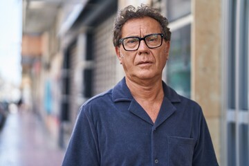 Fototapeta premium Middle age man with relaxed expression standing at street