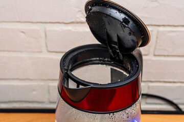 new modern boiling glass electric kettle close-up with bubbling water