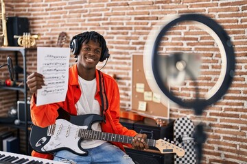 African american man artist having electrical guitar online lesson at music studio