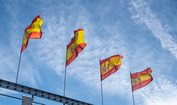 flags of spain waving in the wind