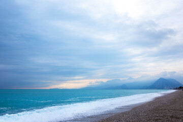 Storm in the Mediterranean Sea. Beautiful rocky shore with rolling waves. Turkiye, Antalya.