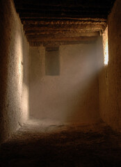 room in one of the old Arab heritage houses and sunlight entering from the window
