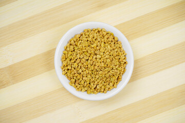 Fenugreek seeds top view on cutting board