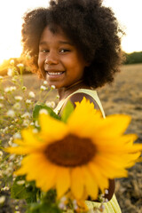 Pretty afro american girl in a sunflowers field