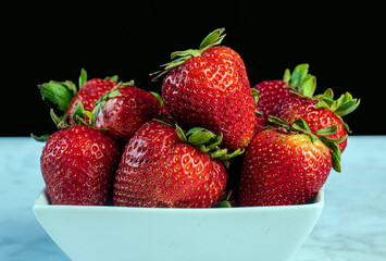 fresh strawberries arranged in a bowl,