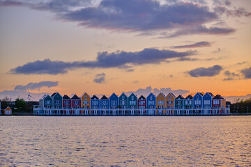 Houten, The Netherlands - April 25 2023. Colourful wooden lakeside houses reflected in the water of...
