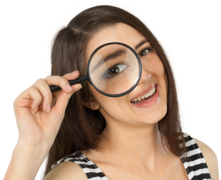 Friendly Young Woman Looking Through Magnifying Glass - Isolated