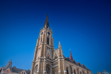 Fototapeta na wymiar The Name of Mary Church, also known as Novi Sad catholic cathedral or crkva imena marijinog during a sunny summer afternoon. This cathedral is one of the most important landmarks of Novi Sad, Serbia.