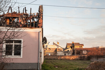 Fototapeta na wymiar Damaged farm house of Banatsko Novo Selo in Banat, Serbia, with a burnt roof that suffered serious fire damage after an accidental disaster destroying most of the wooden structure of the building.
