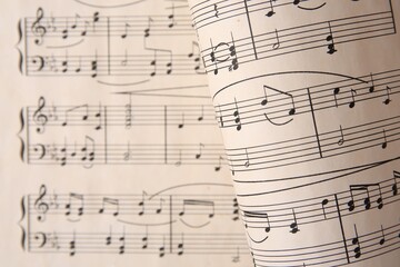 Sheets with music notes as background, top view. Space for text