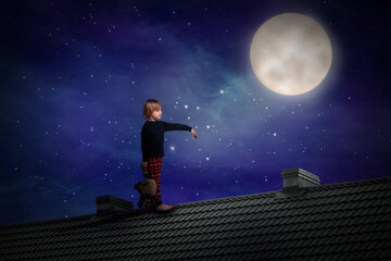 Fototapeta na wymiar Boy holding toy and sleepwalking on roof under starry sky with full moon
