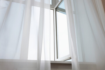 Open window and elegant white curtains indoors. Interior design